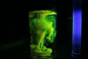 Fluorescein turns bright green under blue light.